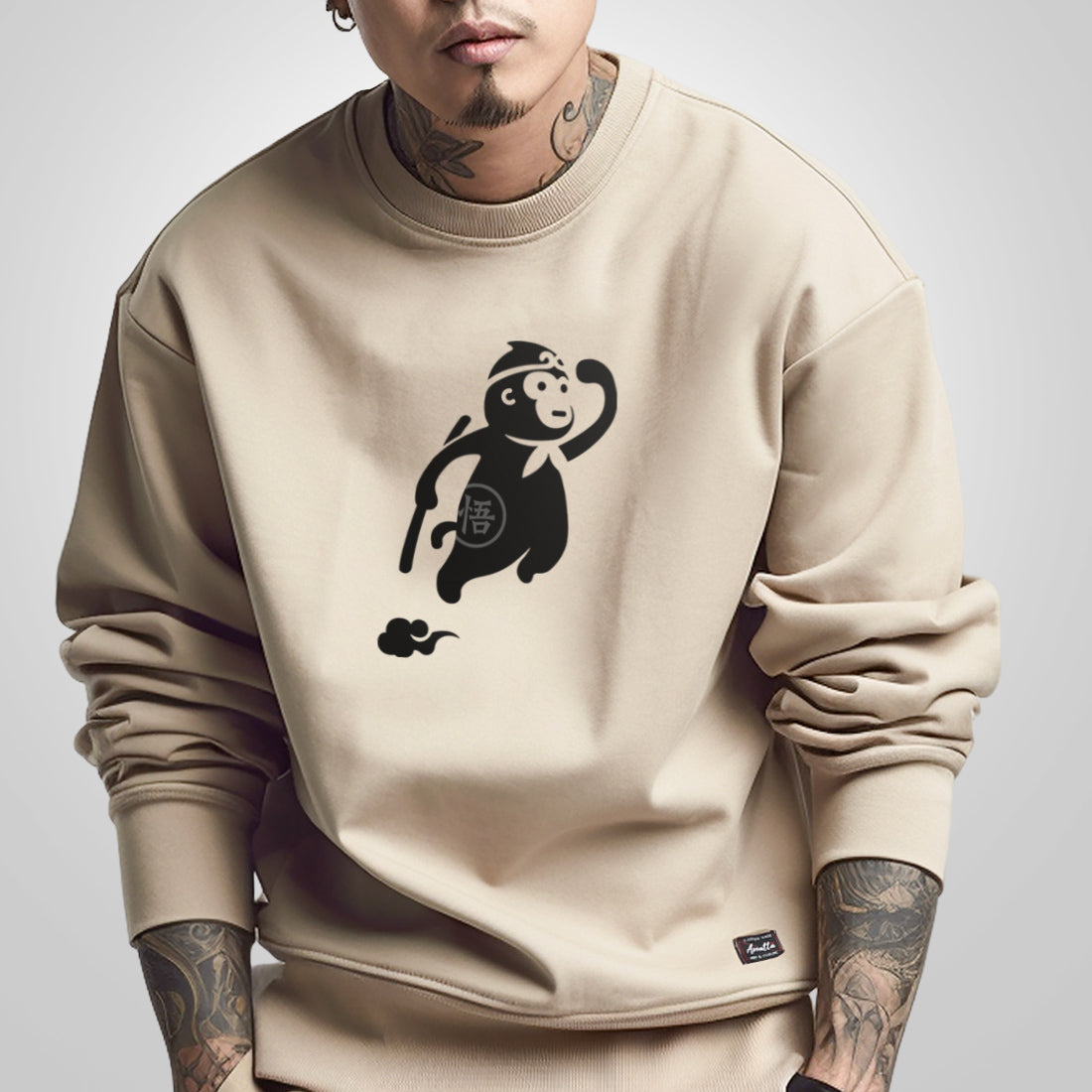 a model wearing a Japanese style khaki sweatshirt, featuring a cute design of the oversized wukong, printed on the front - Anatta Streetwear