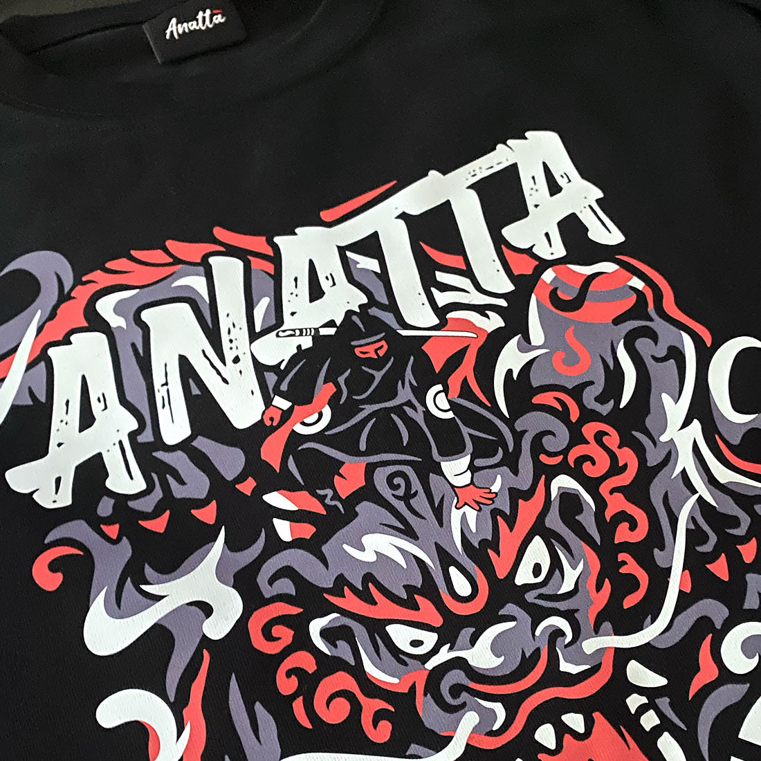 a close-up of a design showcasing a ninja controlling a mythical beast, printed on the Japanese style heavyweight T-shirt-1, anatta streetwear