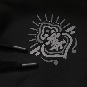 a close-up of a small graphic design, printed on the left chest of the Japanese style black hoodie - Anatta Streetwear