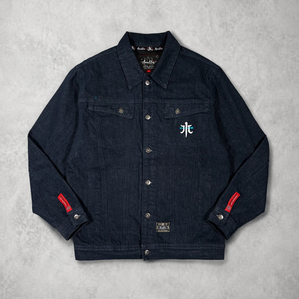 Front view of the Rogue Wave denim jacket featuring heavyweight cotton denim, chest embroidery, and red sleeve labels.