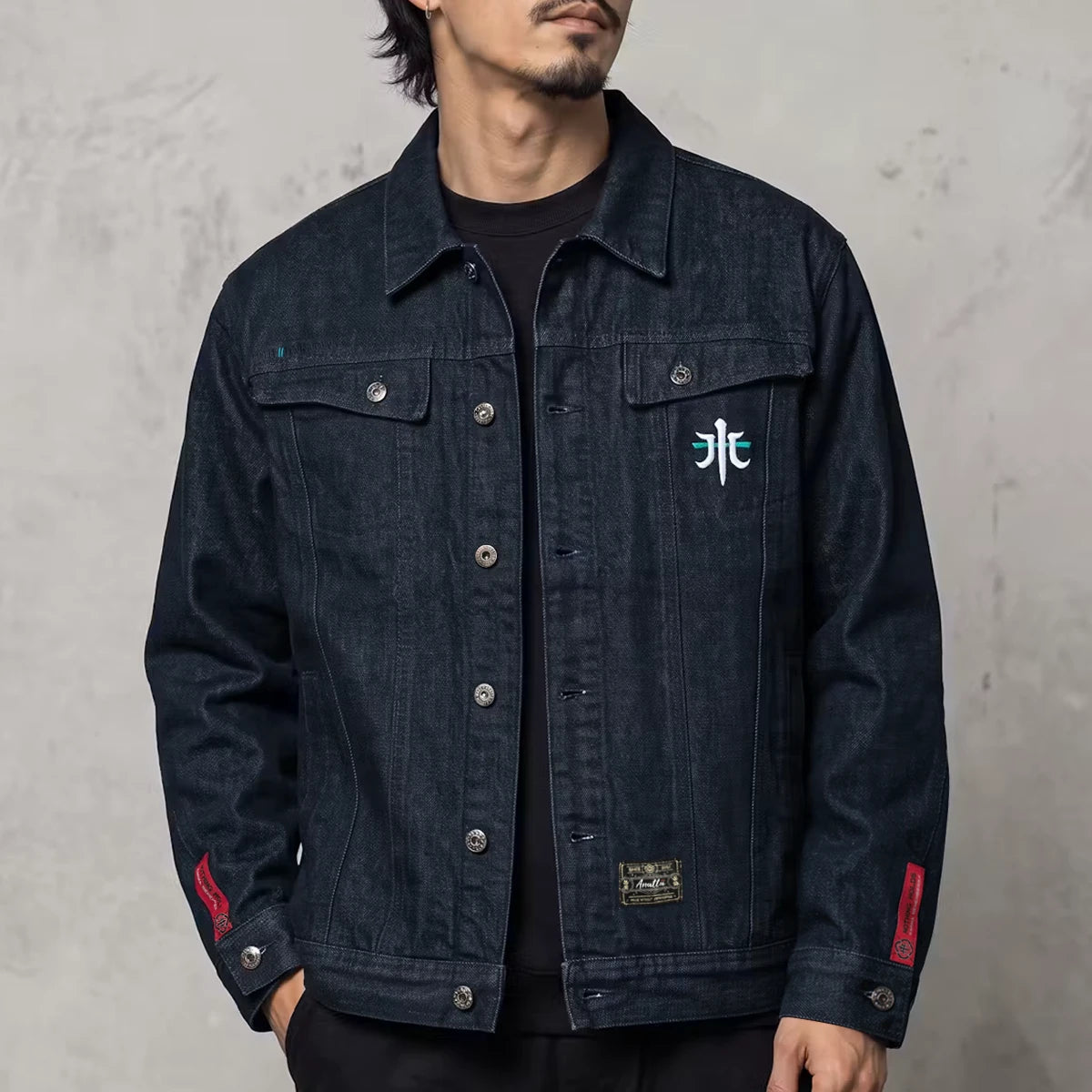 Model wearing the Rogue Wave denim jacket from the front, showing the heavyweight indigo denim and chest embroidery.
