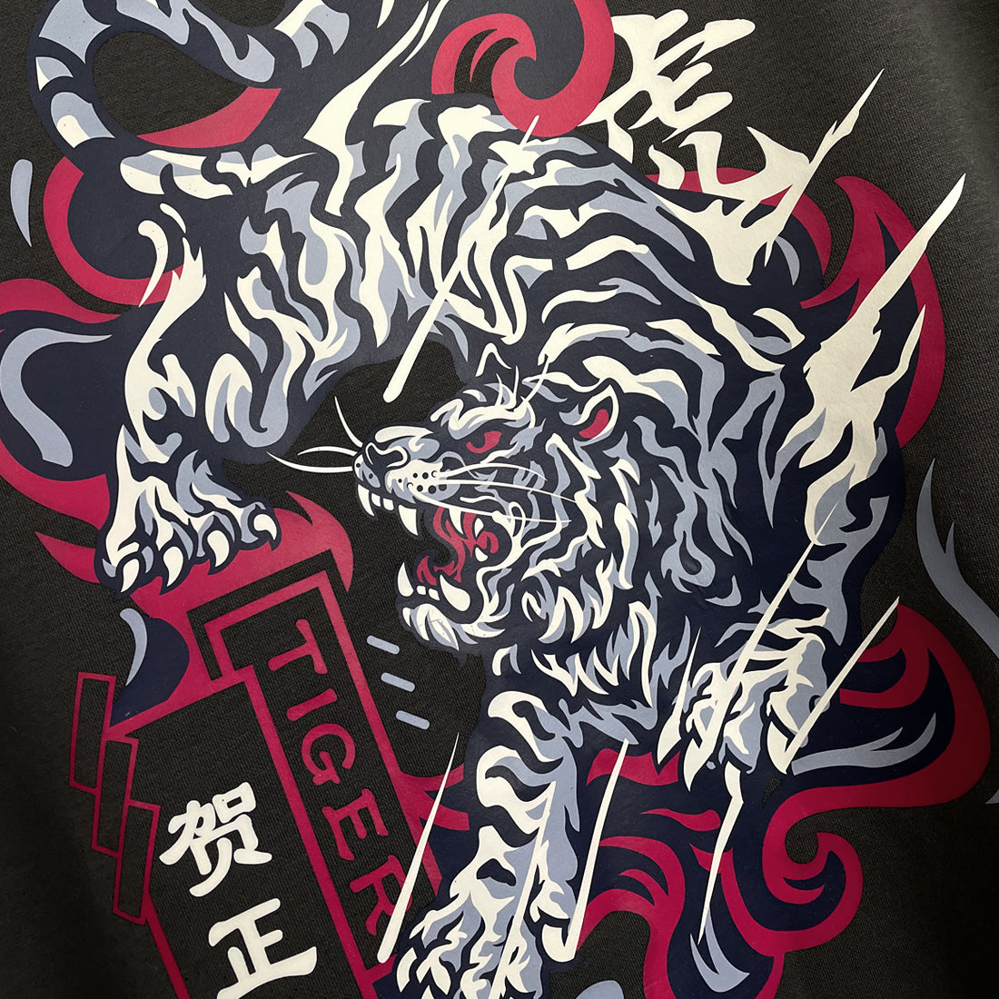 The tiger - a close-up of an intricate illustration of a fierce Japanese tiger printed on the back of a Japanese style black hoodie-1