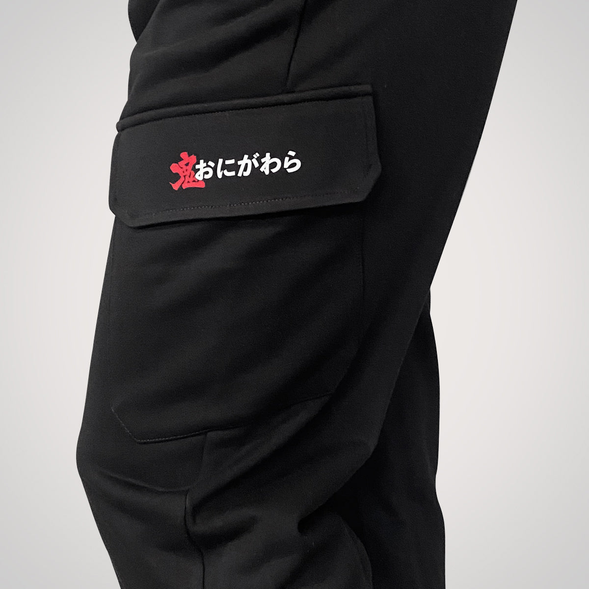 Onigawara - a Japanese style black flap pocket pants with original design printed on the two pockets- left side view