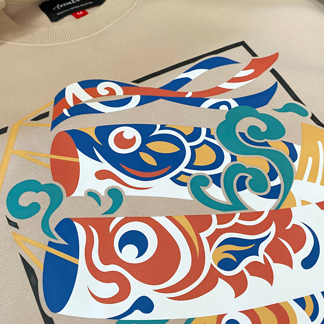 Koinobori- a close-up of a design of Japanese carp streamers printed on the front of a khaki sweatshirt -1