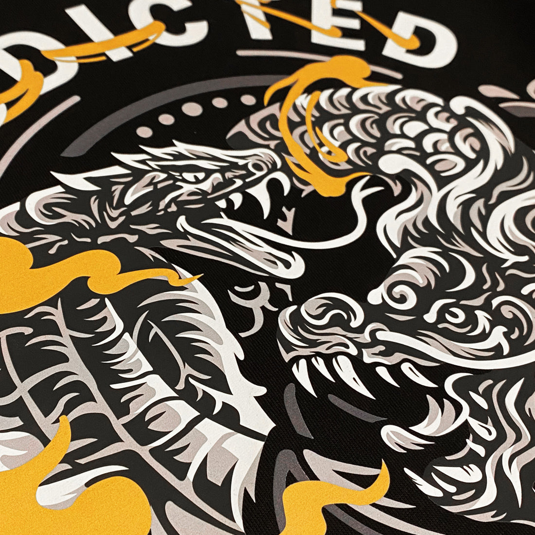 Addiction- a close-up of a design of a dragon and a snake in combat, printed on the front of a black sweatshirt-1