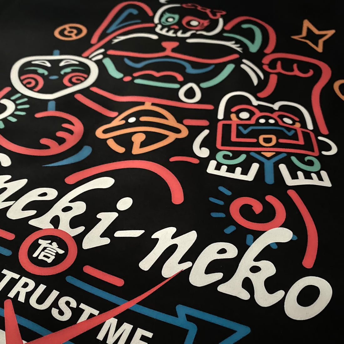 Not to believe in luck- a close-up of a Japanese luck cat design printed on the front of a black sweatshirt