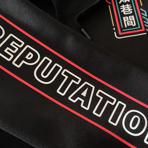 Neon - a close-up of the graphic design on a Japanese style black hoodie sleeve
