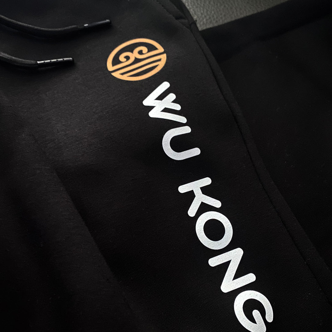 Wukong - a close-up of the word Wukong and an accompanying icon, printed on the Japanese style black sweatpants