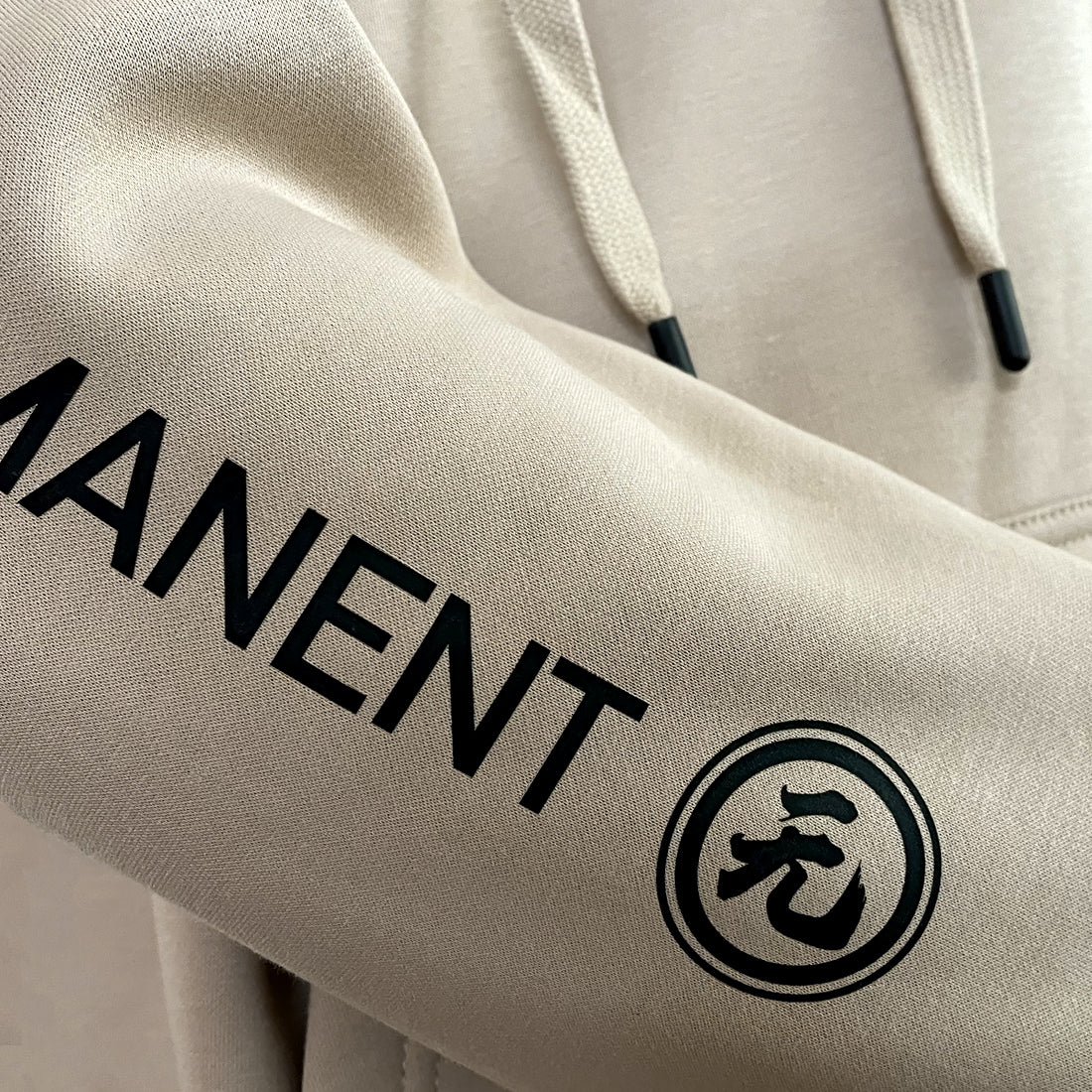 Mudra - a close-up of the graphic design on a Japanese style Khaki hoodie sleeves