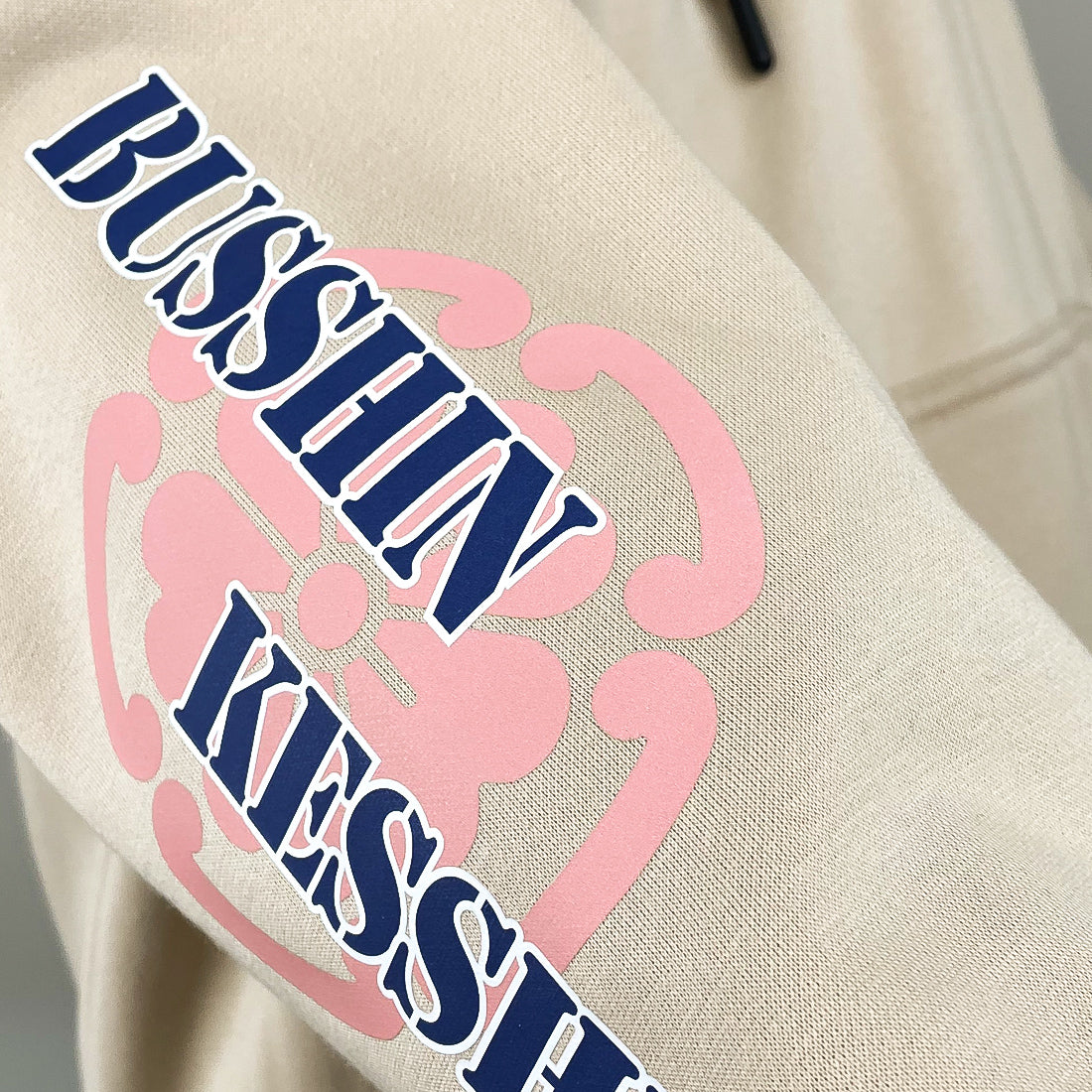Omamori - a close-up of the graphic design on a Japanese style khaki hoodie sleeve