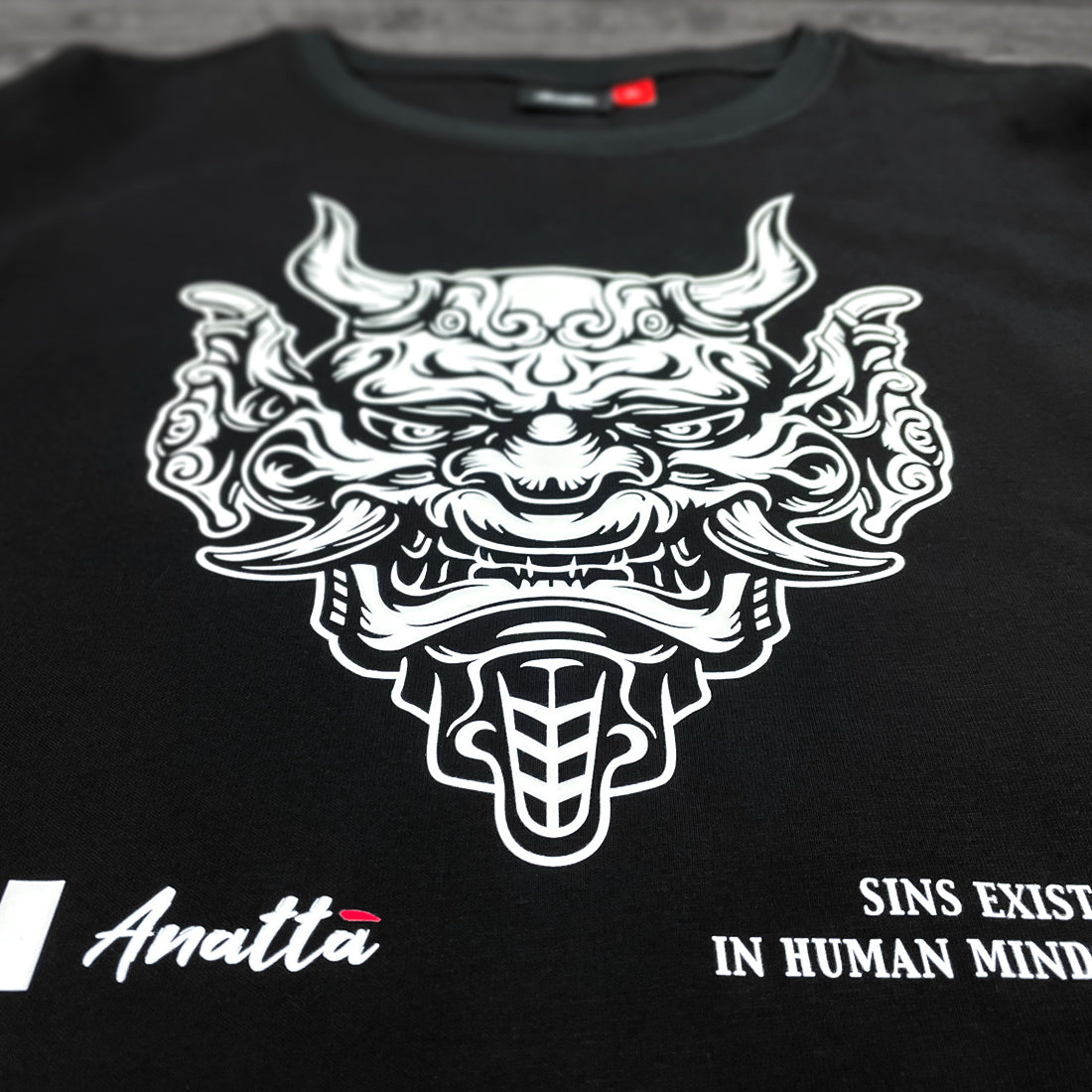 Sins Exist In Human Minds - a close-up of the graphic design inspired by Japanese Oni masks, printed on a Japanese style black heavyweight T-shirt-2