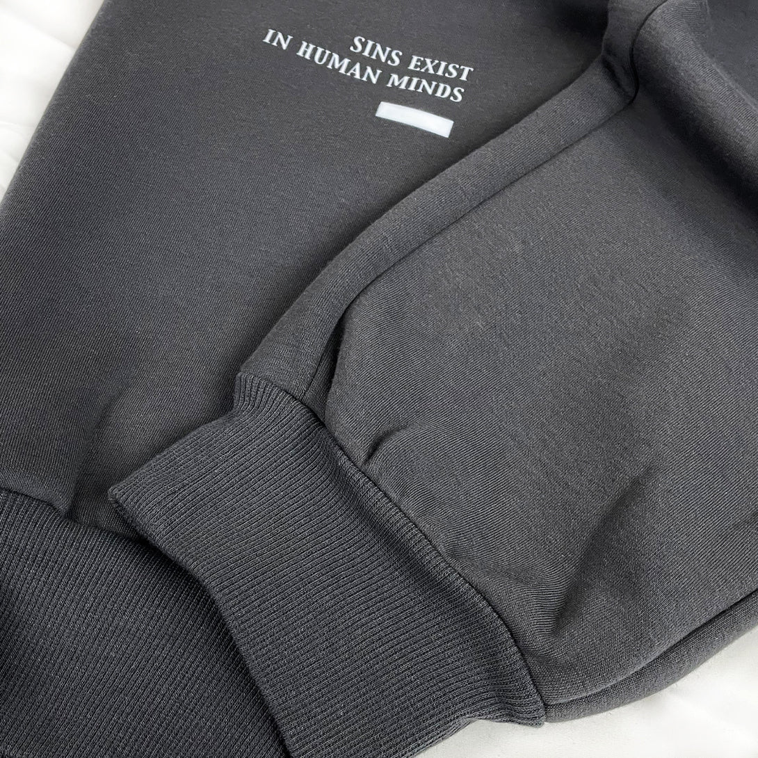 Sins Exist In Human Minds  - a close-up of the craftsmanship at the hem of the Japanese style dark grey sweatpants.